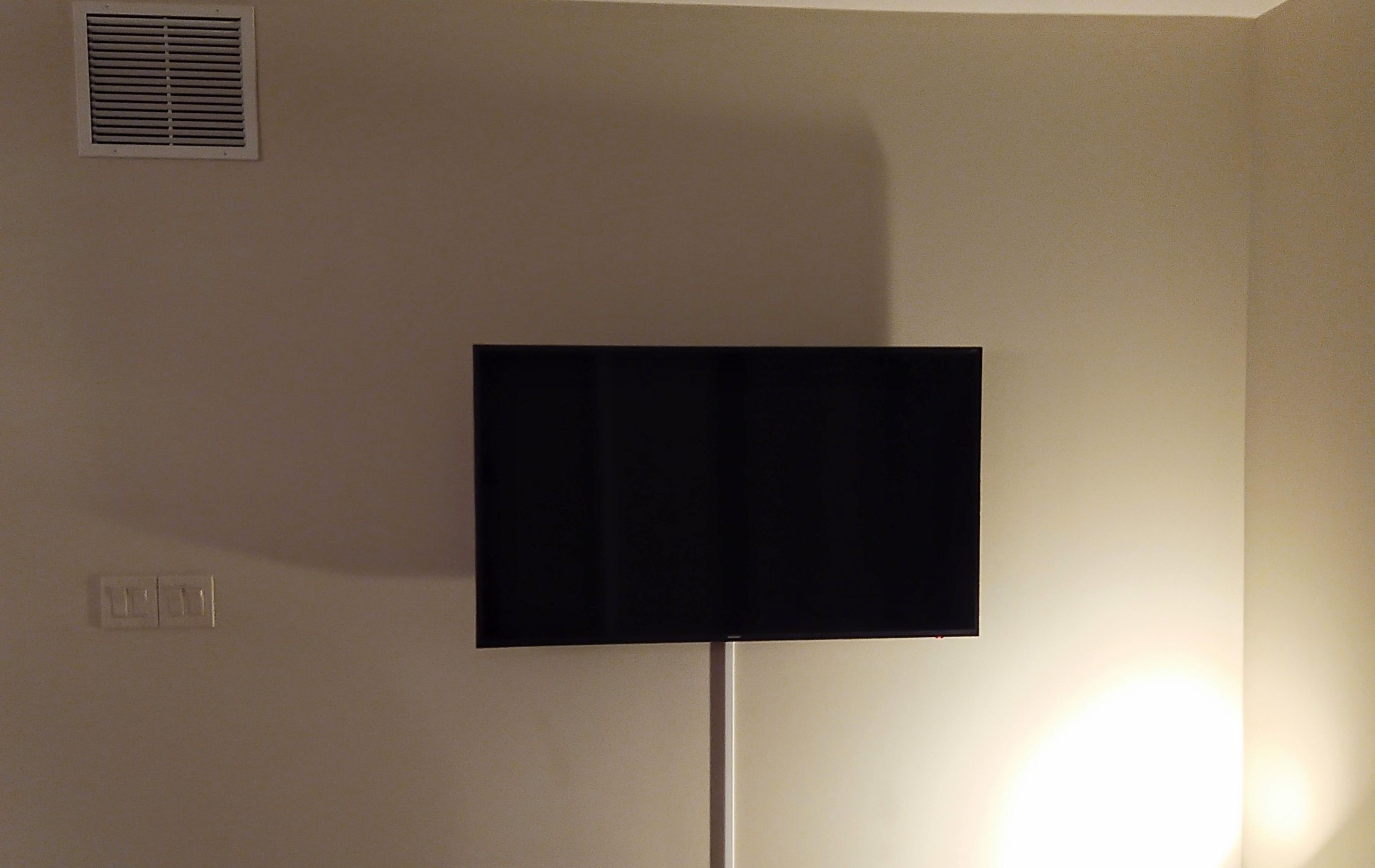 TV wall mounted installation with surface cord concealment